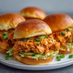 Tray of mini sliders with crispy chicken and Bang Bang sauce