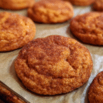 Cookies on a cooling rack dusted with cinnamon sugar