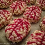 Close-up of brain-shaped rice krispies with glossy red candy melt.