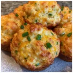 Golden mashed potato cheese puffs on a platter