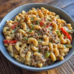 Bowl of cheesy mac and cheese loaded with beef and peppers