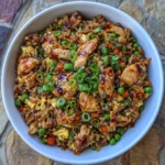 Japanese BBQ chicken fried rice in a skillet with steam rising