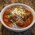 Close-up of chunky chili with tender beef, beans, and fire-roasted tomatoes.