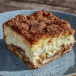 Close-up of cheesecake bar layers with cinnamon sugar crust
